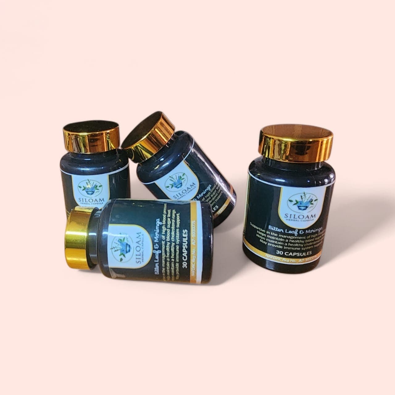 Four Siloam Herbal Capsule bottles on a soft pink background